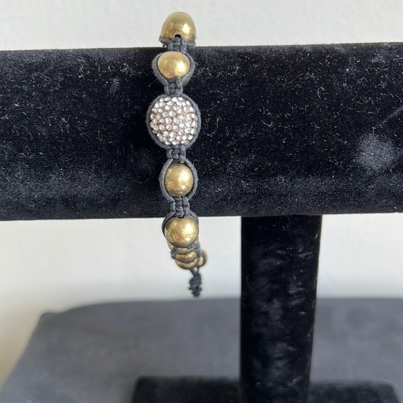Jewelry - Gold tone bracelet on black cord